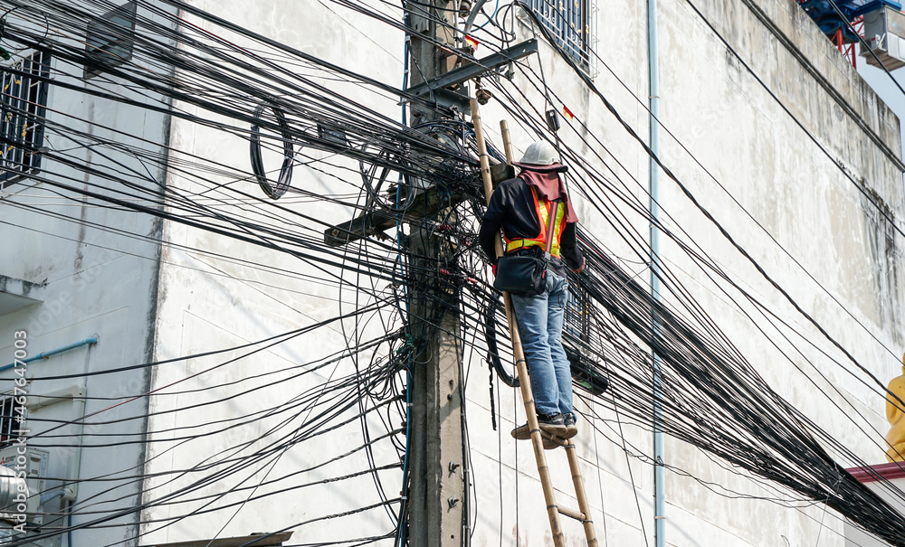 Fototapeta premium Power line on electric power pole. electricians repairing. telephone line, intercom