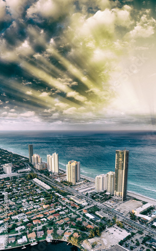Amazing skyline of Miami Beach. Aerial view of city buildings from helicopter on a cloudy sunset © jovannig