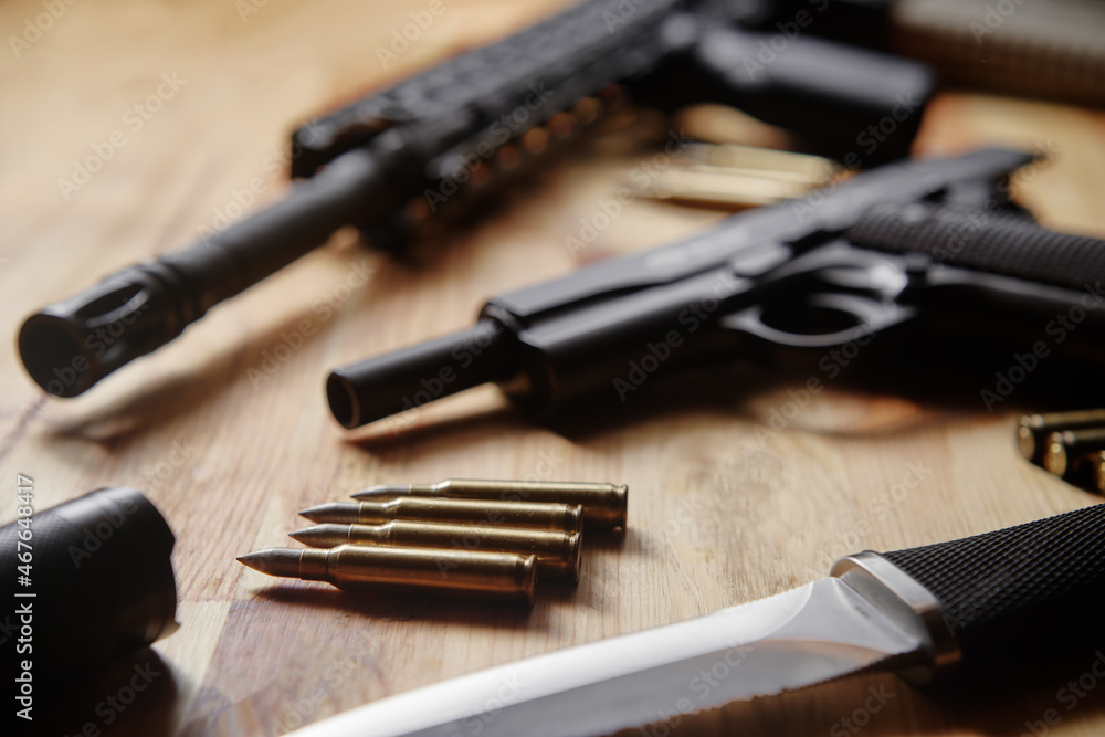 Weapons and military equipment for army, Assault rifle gun, handgun and knife on wooden background. Weapons and military equipment for army, Assault rifle gun, handgun and knife on wooden background.