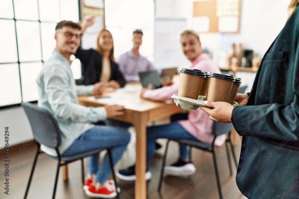 Group of business workers smiling happy working at the office. Partner man holding tray with take away coffee. Group of business workers smiling happy working at the office. Partner man holding tray with take away coffee.