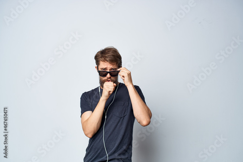 handsome man in a black t-shirt music in headphones movement studio lifestyle
