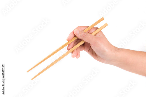 Obraz na płótnie Person 's right hand using bamboo chopsticks against white background