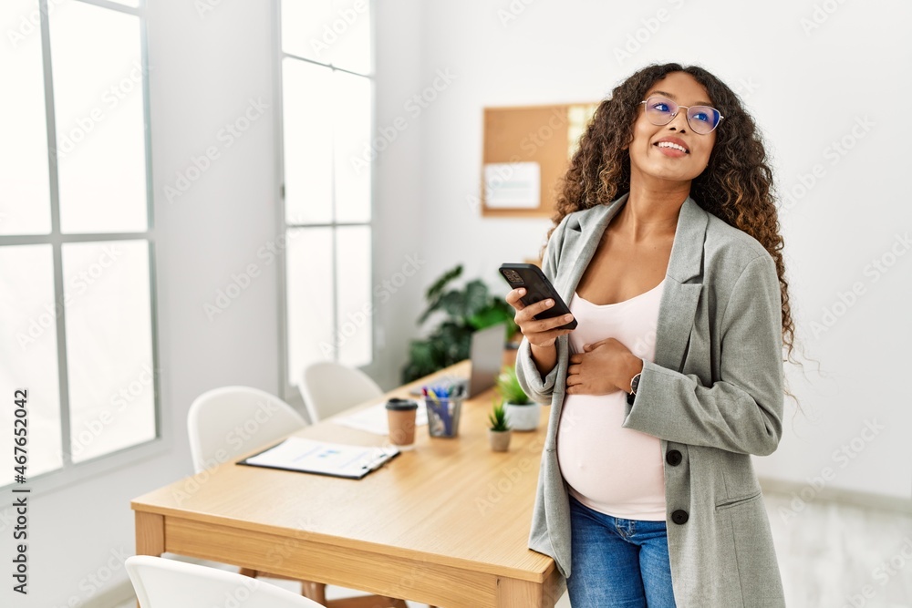 Young latin woman pregnant smiling confident using smartphone working at office Young latin woman pregnant smiling confident using smartphone working at office