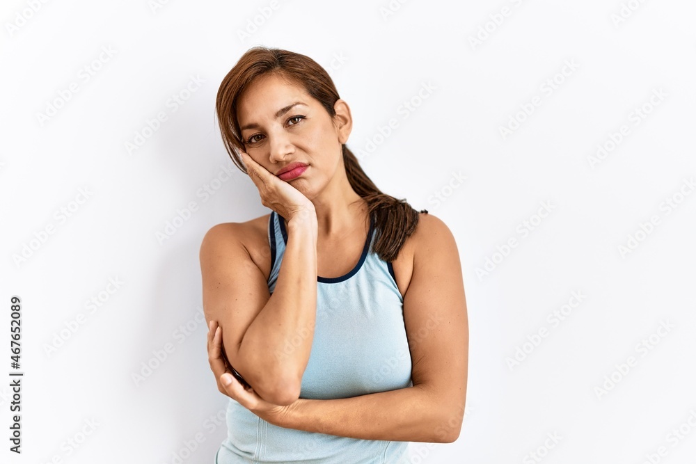 Young latin woman wearing sporty clothes over isolated background thinking looking tired and bored with depression problems with crossed arms. Young latin woman wearing sporty clothes over isolated background thinking looking tired and bored with depression problems with crossed arms.
