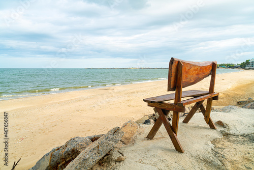 wood bench on beach with sea beach background