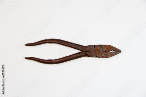 Rusty pliers on the white background
