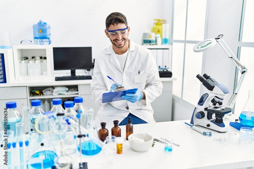 Handsome hispanic man working as scientific at laboratory Handsome hispanic man working as scientific at laboratory