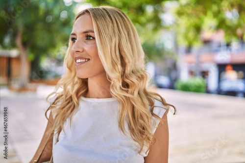 Young blonde woman smiling confident at park