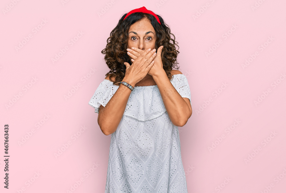 Middle age hispanic woman wearing casual clothes shocked covering mouth with hands for mistake. secret concept. Middle age hispanic woman wearing casual clothes shocked covering mouth with hands for mistake. secret concept.