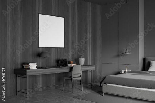 Square canvas and desk in dark grey bedroom. Corner view.