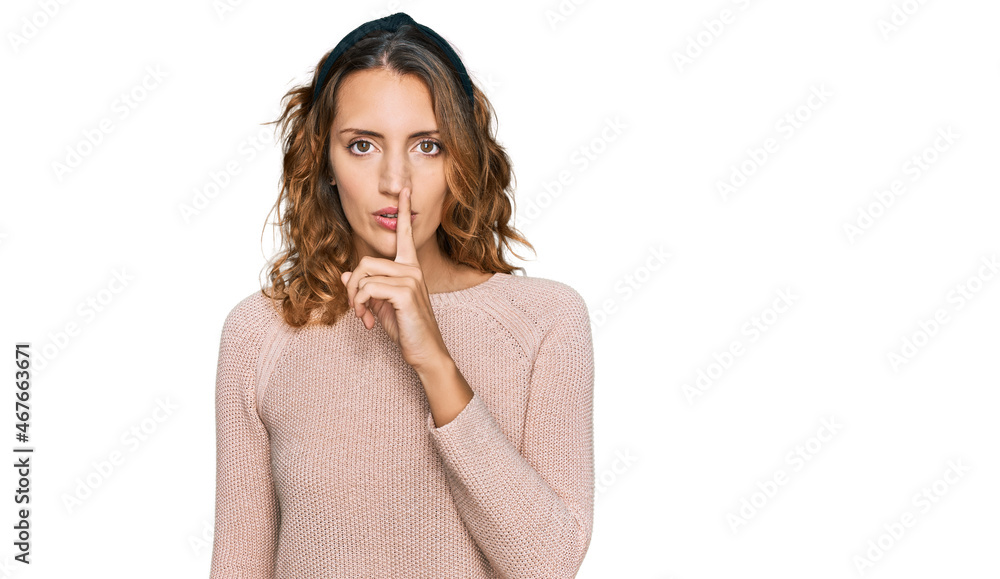 Beautiful young caucasian woman wearing casual sweater asking to be quiet with finger on lips. silence and secret concept. Beautiful young caucasian woman wearing casual sweater asking to be quiet with finger on lips. silence and secret concept.
