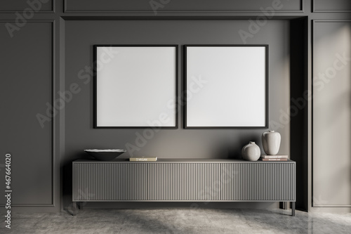 Two empty frame mockups on wall in grey living room