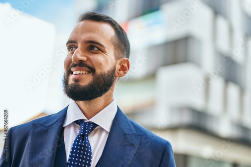 Young businessman smiling happy standing at the city.