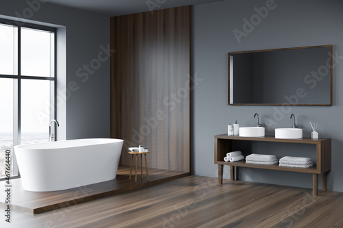 Grey and wood bathroom space with open vanity. Corner view.