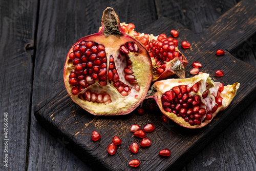 Ripe pomegranate on a dark wooden background
