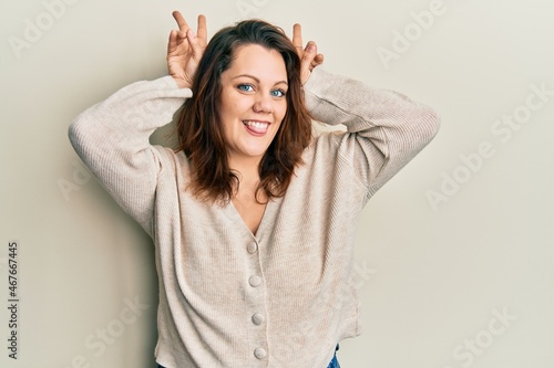 Young caucasian woman wearing casual clothes posing funny and crazy with fingers on head as bunny ears, smiling cheerful