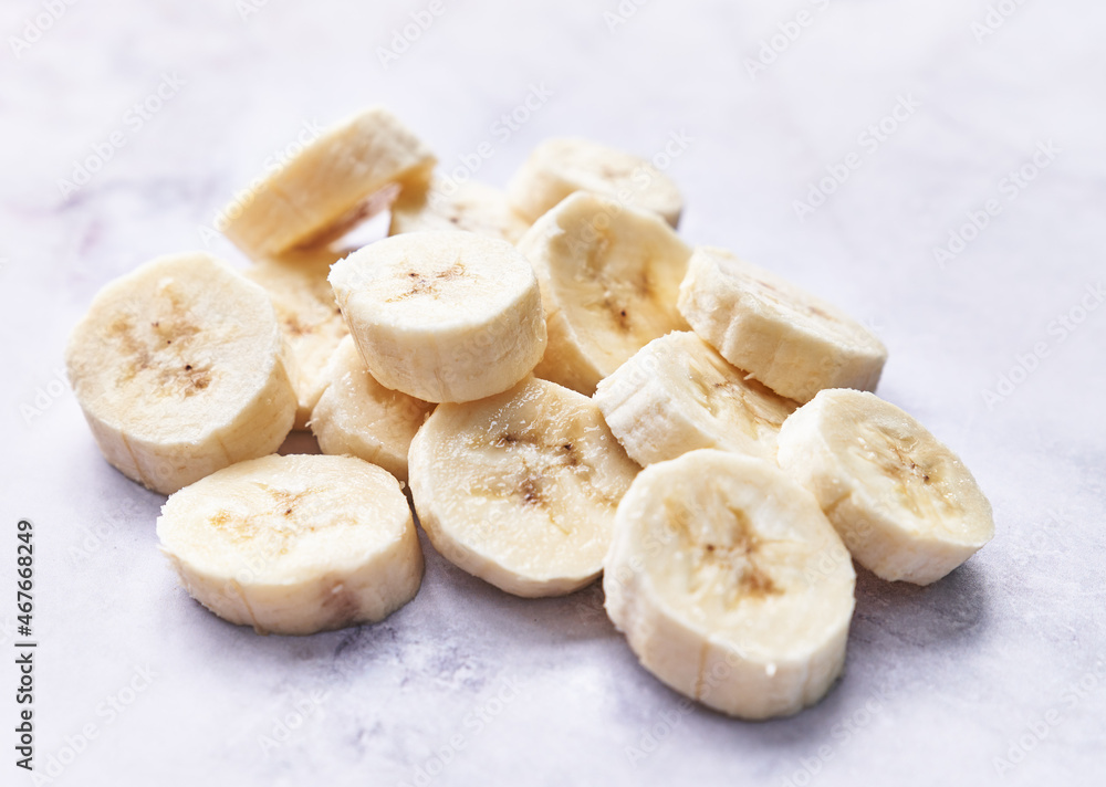 Slices of banana on a marble table Slices of banana on a marble table