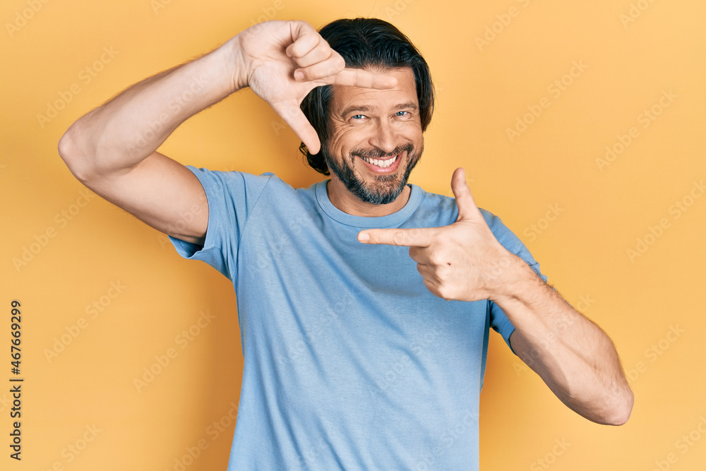 Middle age caucasian man wearing casual clothes smiling making frame with hands and fingers with happy face. creativity and photography concept. Middle age caucasian man wearing casual clothes smiling making frame with hands and fingers with happy face. creativity and photography concept.