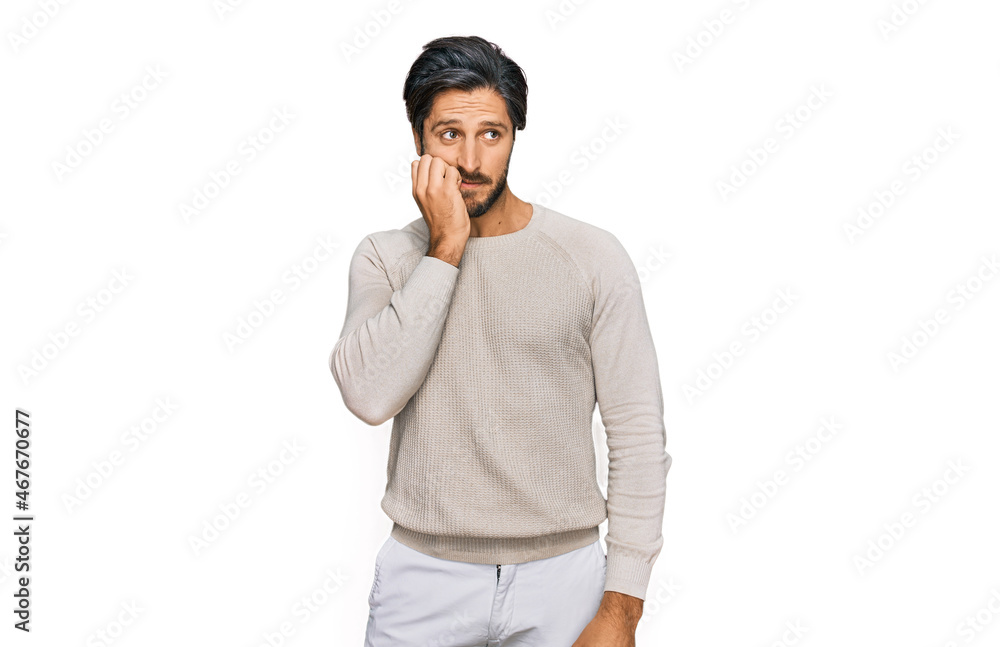 Young hispanic man wearing casual clothes looking stressed and nervous with hands on mouth biting nails. anxiety problem. Young hispanic man wearing casual clothes looking stressed and nervous with hands on mouth biting nails. anxiety problem.