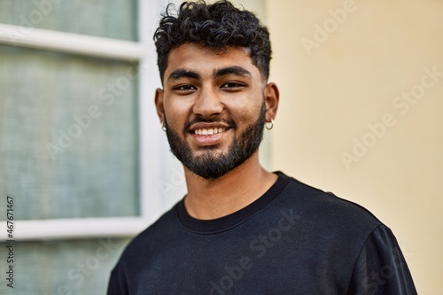 Young arab man smiling confident at street © Krakenimages.com