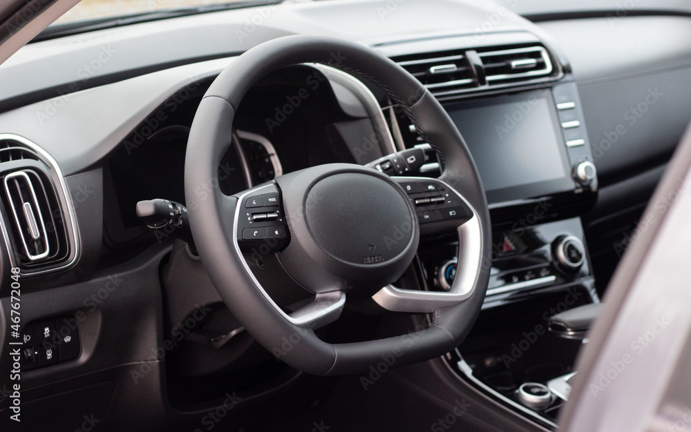The interior of a new car. Steering wheel, tablet, automatic transmission, instrument panel