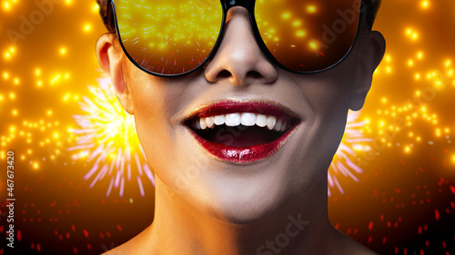 Holiday. Reflection of bright fireworks in glasses of a happy young woman, close-up portrait using effects