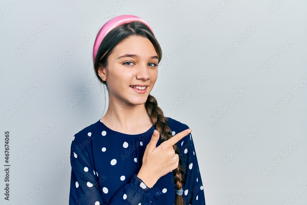 Young brunette girl wearing elegant look cheerful with a smile of face pointing with hand and finger up to the side with happy and natural expression on face Young brunette girl wearing elegant look cheerful with a smile of face pointing with hand and finger up to the side with happy and natural expression on face