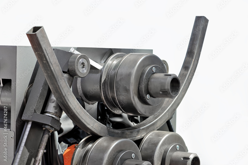Industrial machine for bending steel pipes and metal rods. Pipe bending machine on white background - obrazy, fototapety, plakaty 