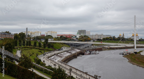 View from the granite embankment to the bridge of lovers in the city of Tyumen in autumn