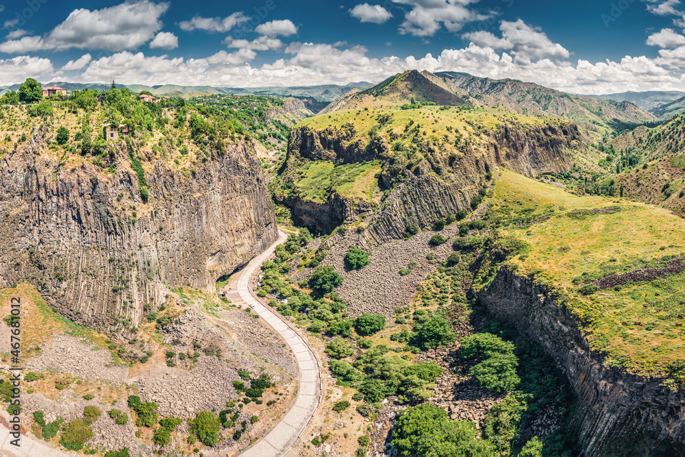Car road and a pedestrian path leading to majestic gorge of Azat river canyon - a Symphony of Stones or basalt Pillars in Garni, Armenia