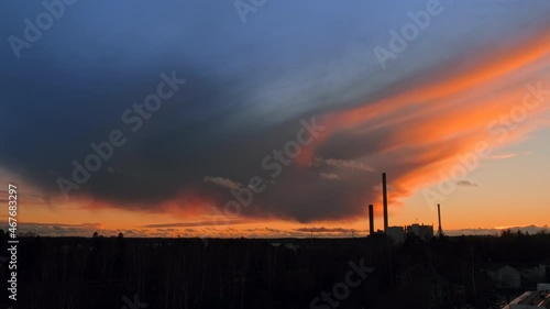 Amazing autumn sunset in Nordic Europe. In the foreground are the pipes of the Coal Heat Power Plant. Concept of Environmental protection.