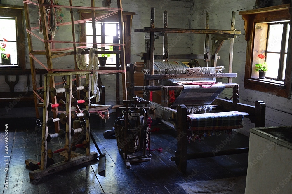 Historical room of weaver with weaving loom, coil holders and other mechanism used in manual