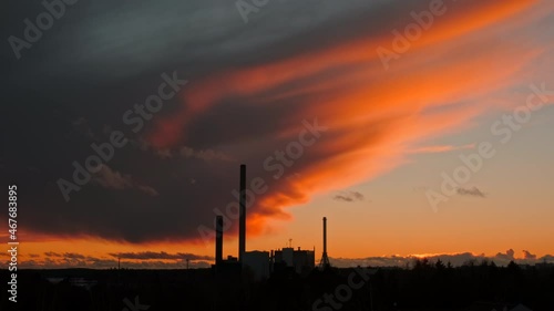 Amazing autumn sunset in Nordic Europe. In the foreground are the pipes of the Coal Heat Power Plant. Concept of Environmental protection.