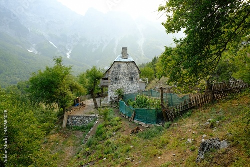 Fototapeta Naklejka Na Ścianę i Meble -  Beautiful mountain views with traditional rural stone house with garden around Valbona Valley in Albanian Alps. 
