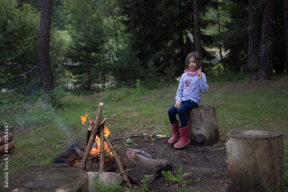 child sitting on a fire child sitting on a fire