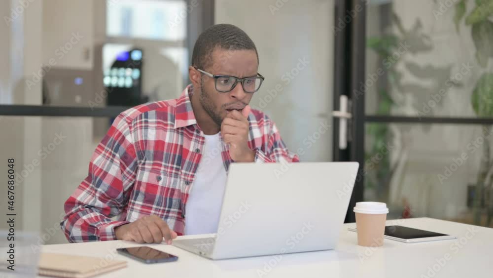 African Man Feeling Shocked While using Laptop African Man Feeling Shocked While using Laptop