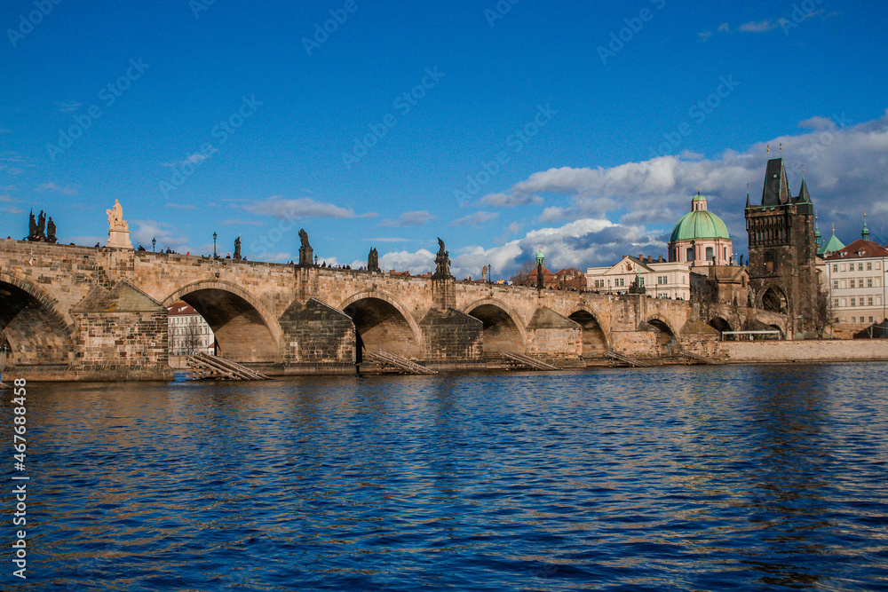 Charles Bridge in clear weather, blue sky with clouds