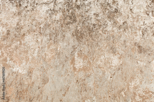 Natural stone texture. Closeup of layered rough grainy rock surface. Flat lay, top view. Different shades of brown. Copy space. 