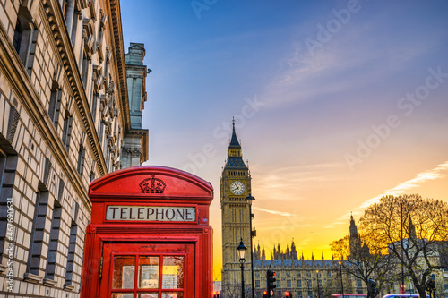 Big Ben with red telephone booth at sunrise in London. England