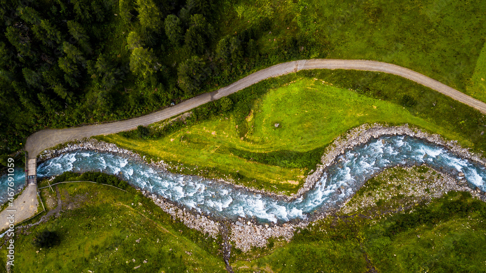 Drone Aerial View Of Clear Mountain River And Forest Road In Deferegental In Tirol In Austria - obrazy, fototapety, plakaty 