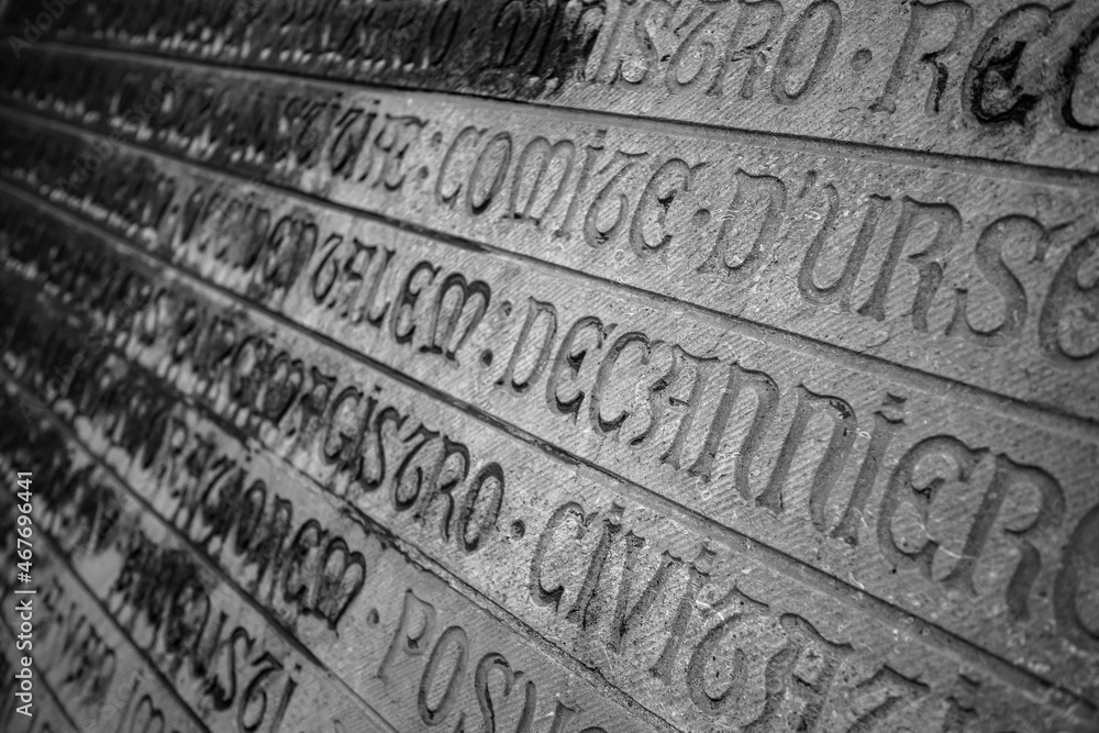 Shallow selective focus of stone-carved letters from the front of the cathedral of Oostende, Belgium