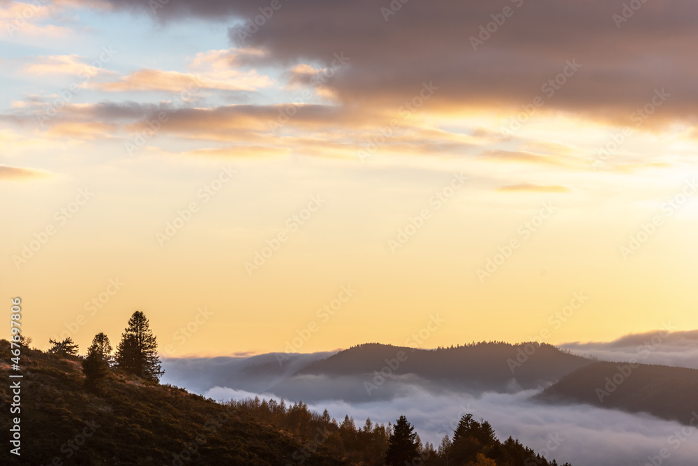 View of the Vosges mountains with fog in the valley at dusk.