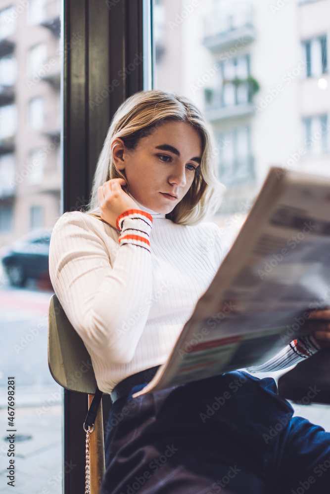 Fototapeta premium Calm woman reading news in cafe