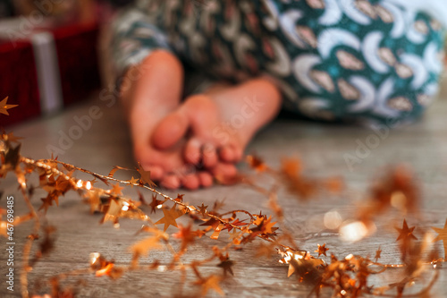 blurred baby's feet with christmas decorations 