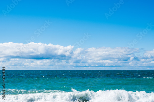 light blue sea and blue sky. waves on the sea in daylight