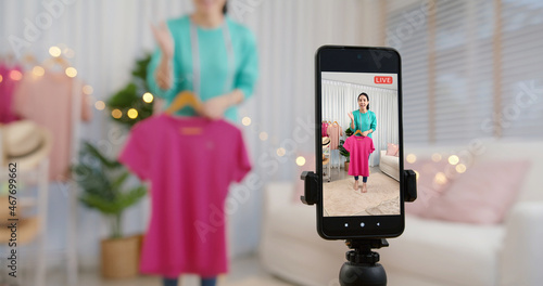Obraz na płótnie Asia vlogger woman influencer, SME retail store owner smile enjoy selling show live sale online screen in IG story reel tiktok work at home studio