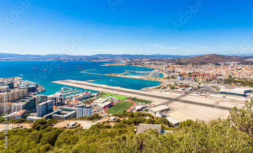 Border between Gibraltar and Spain with runway in the middle, La Linea town in the backgound