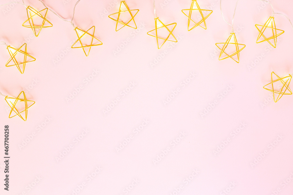 Gold Christmas decorations on a pink background flat lay , top view Gold Christmas decorations on a pink background flat lay , top view