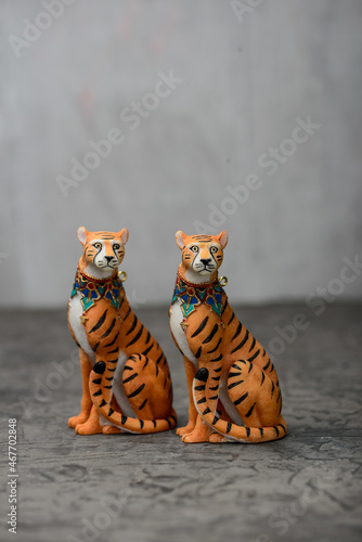 Wallpaper Mural two figurines of tigers on a gray background vertical photo
 Torontodigital.ca