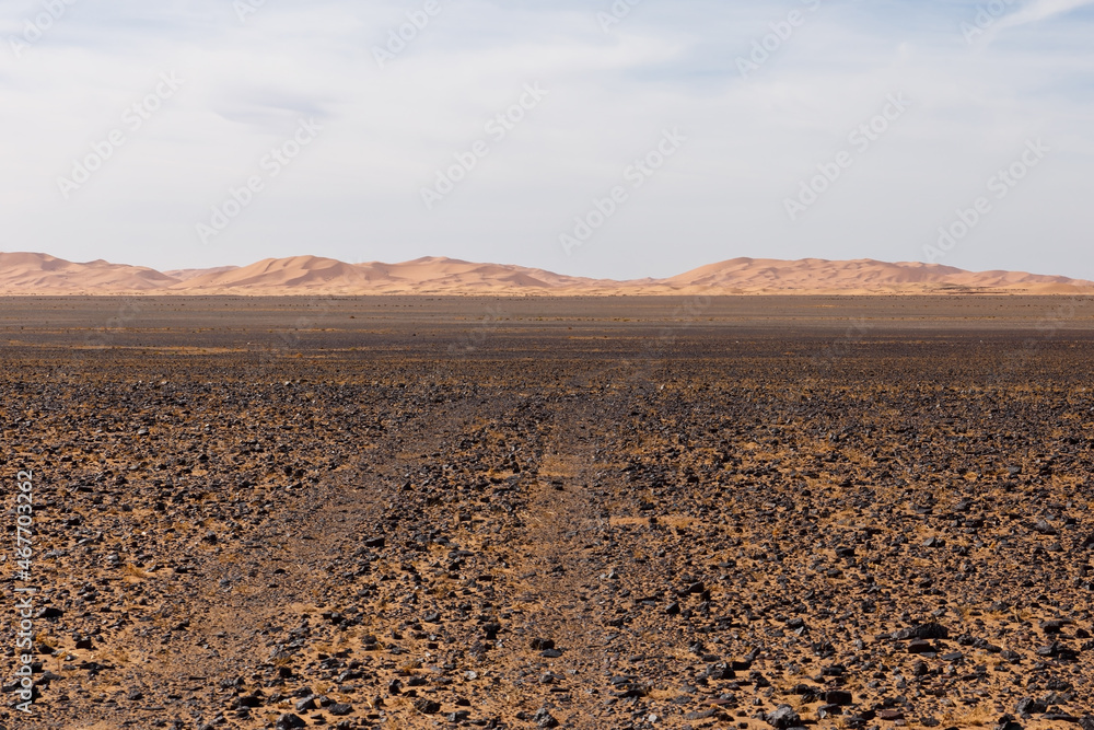 The road through the stone desert to the sand dunes of Erg Chebbi. Sahara Desert Morocco